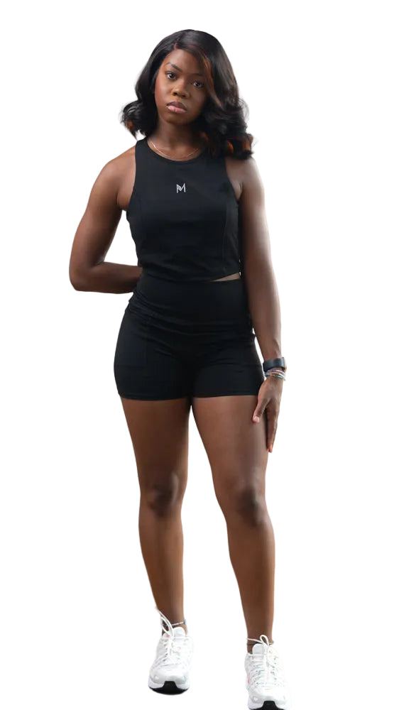 Woman wearing a black tank top and shorts