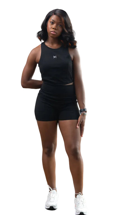 Woman wearing a black tank top and shorts