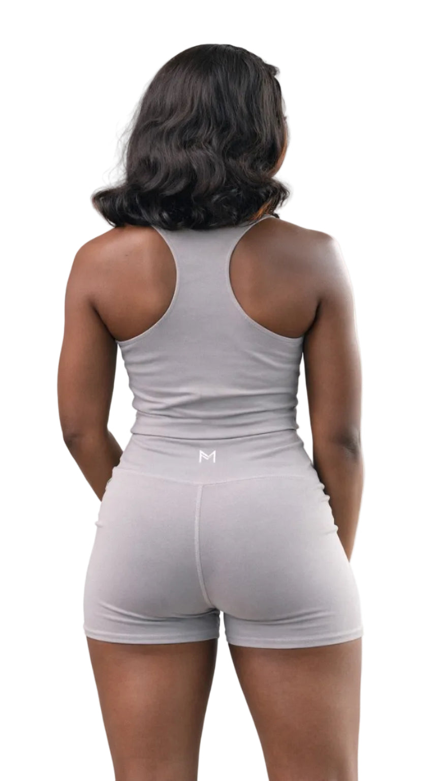 Person wearing a gray tank top and shorts set on a white background