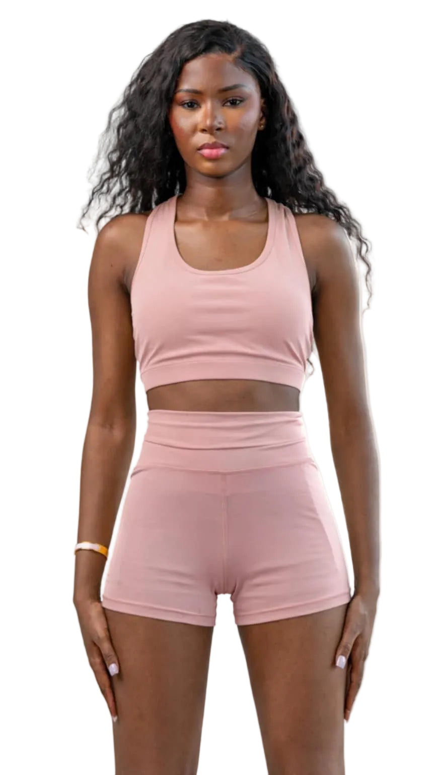 Woman wearing a pink athletic outfit on a white background