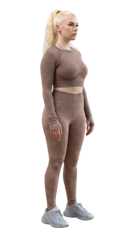 Woman wearing a brown long-sleeve crop top and leggings set on a white background