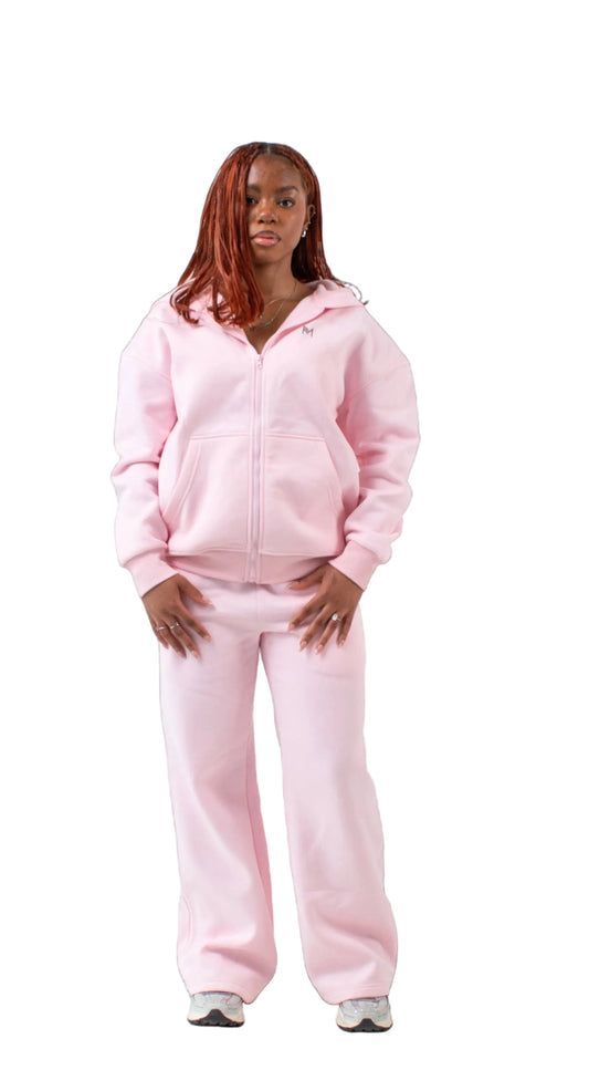 Person wearing a pink tracksuit on a white background