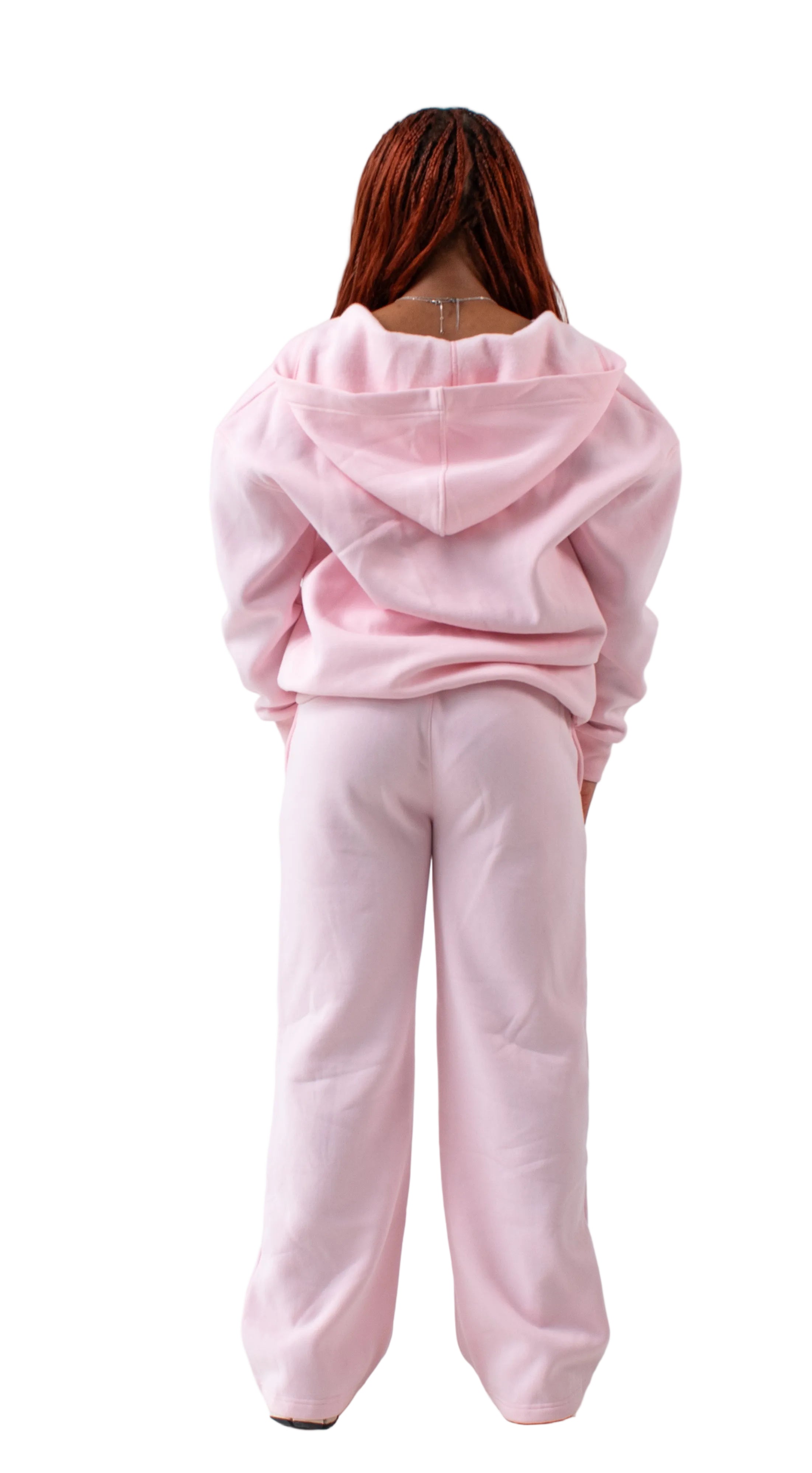 Person wearing a pink tracksuit on a white background