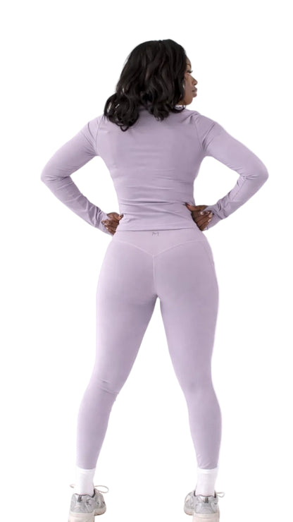 Person wearing a light gray athletic outfit on a white background
