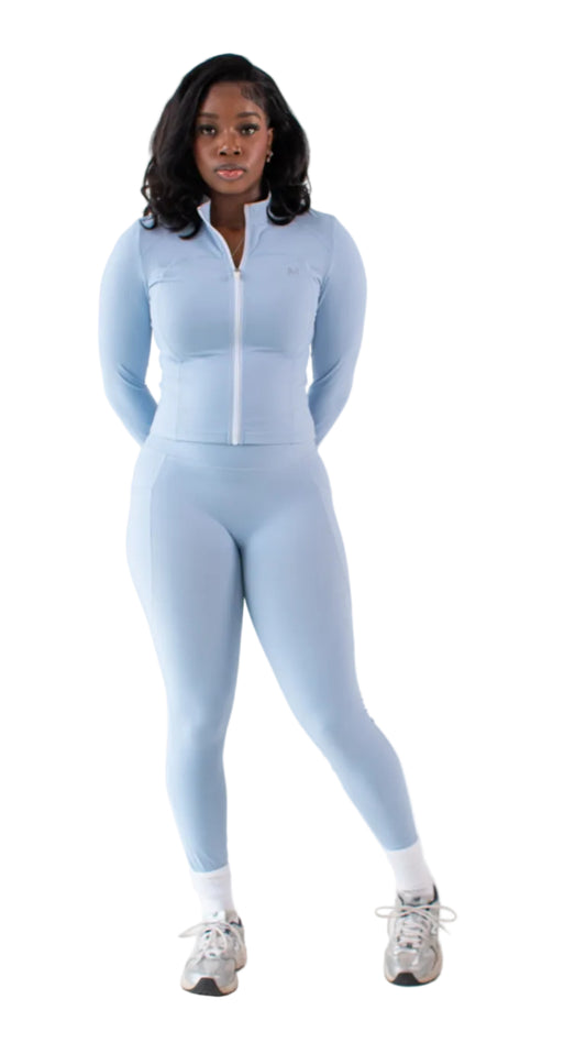 Person wearing a light blue athletic outfit on a white background