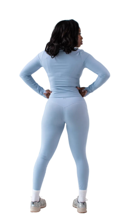 Person wearing a light blue athletic outfit on a white background