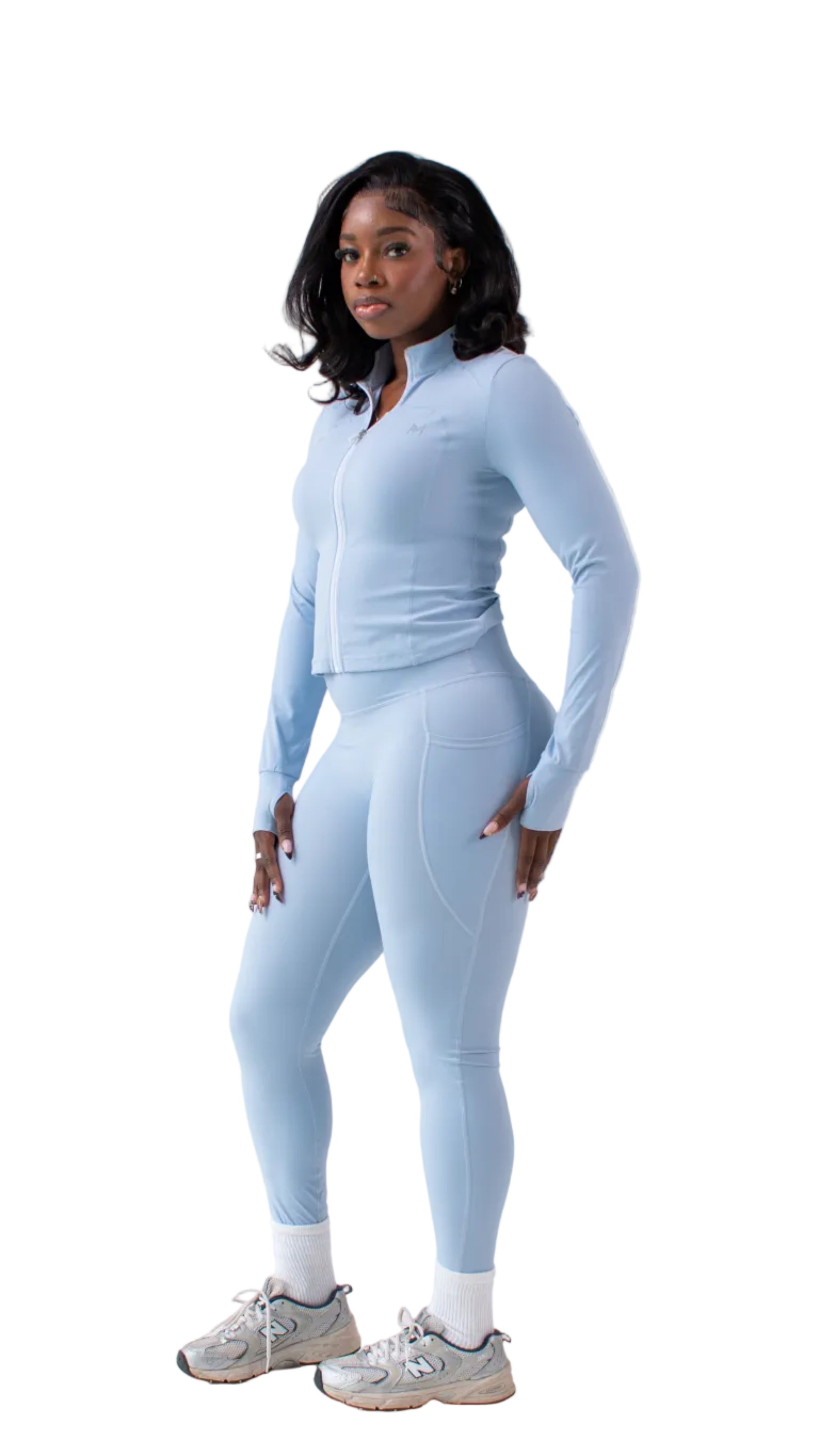 Woman wearing a light blue athletic outfit on a white background